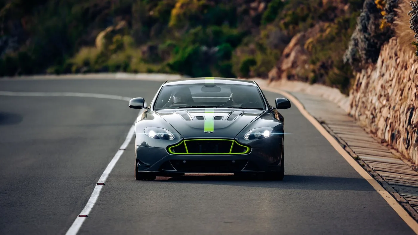 Illustrative dark performance coupe on an open road