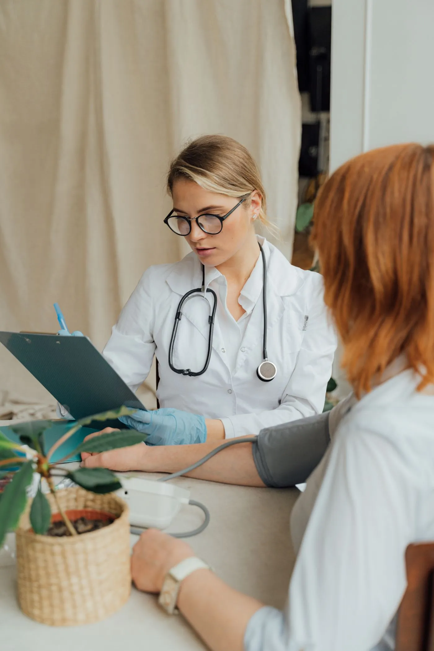 Clinician sitting and talking with a patient during a warm one-on-one consultation in a clinic