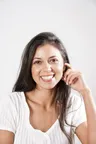 Maya R., a smiling woman in a white top