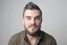 Daniel R., a bearded man in an olive shirt