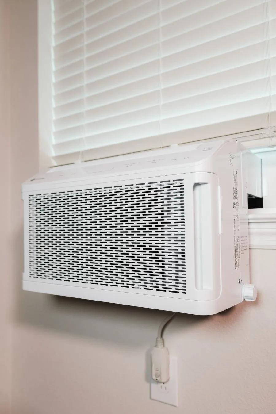 Wall-mounted air conditioning unit in a clean bright home interior